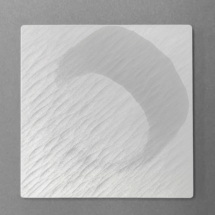Moisture darkens the DRIFT coaster surface, then fades as it dries