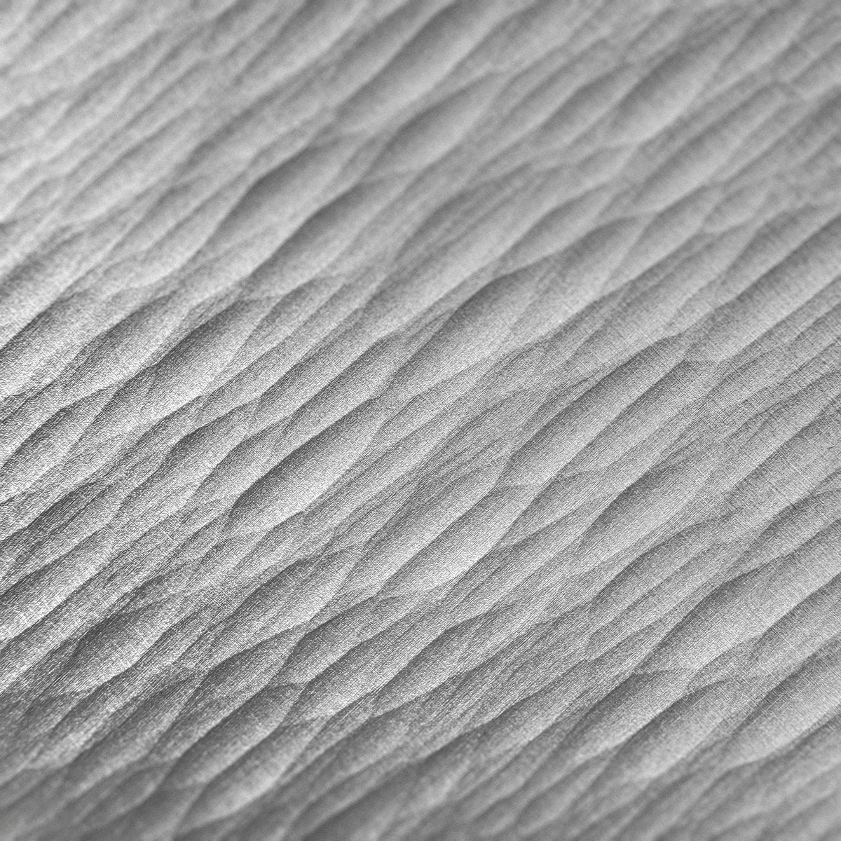 Close-up of directional grooves on the DRIFT aluminum coaster