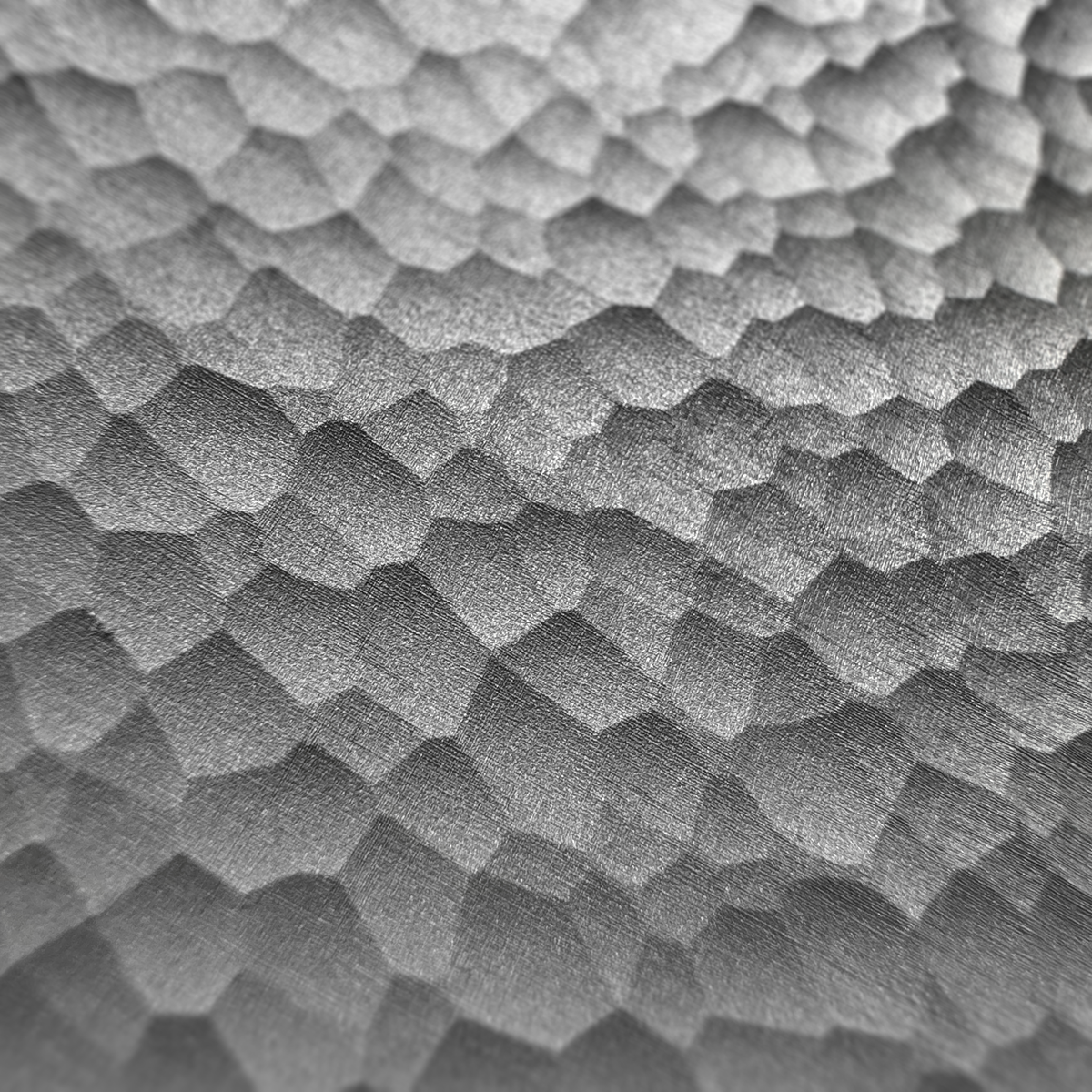 Close-up of the laser-textured cellular surface on a VORONOI aluminum coaster