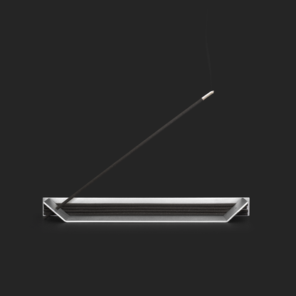 Folded aluminum incense holder with stacked sticks and one burning stick