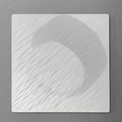 Moisture darkens the DRIFT coaster surface, then fades as it dries